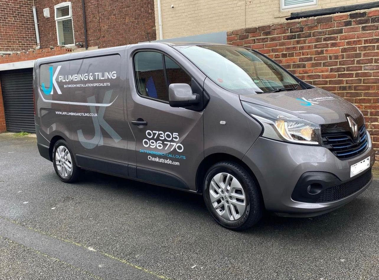 JK Plumbing & Tiling van parked on a residential street